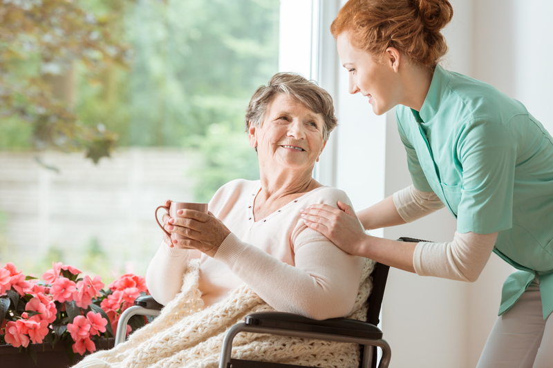 caretaker with an older woman in a wheelchair