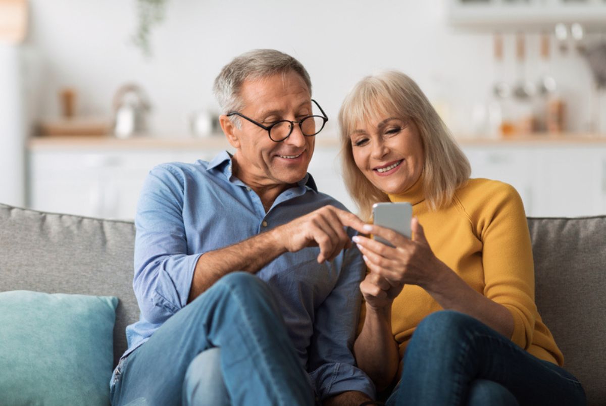 couple looking at phone together; Why are Medicare Advantage plans free?