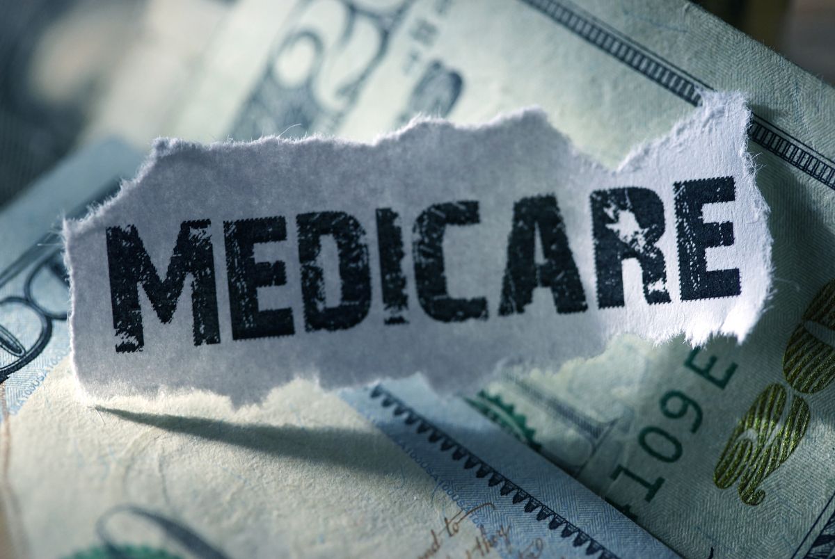 medicare typed on on paper on top of money