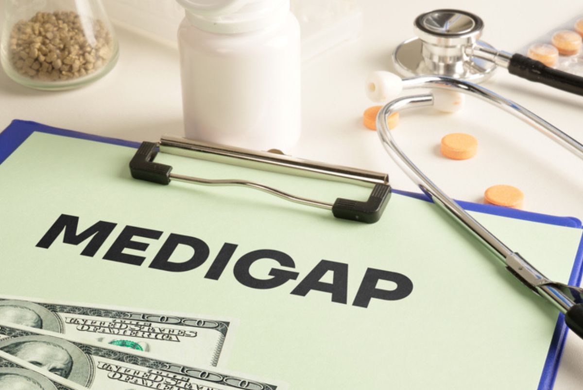 medigap papers and money with pills