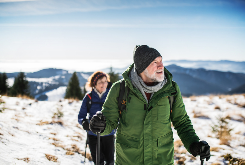medicare age couple in winter hiking